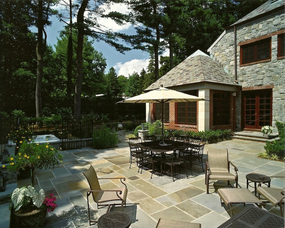 Design ideas for a large traditional backyard patio in New York with tile and no cover.