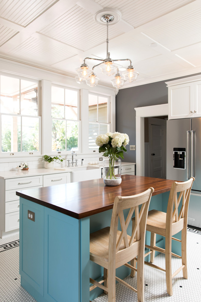 Inspiration for a traditional separate kitchen in Other with a farmhouse sink, shaker cabinets, white cabinets, stainless steel appliances, with island, multi-coloured floor and white benchtop.