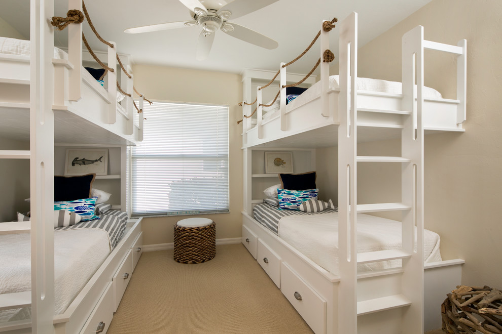 Design ideas for a beach style gender-neutral kids' bedroom in Tampa with beige walls and carpet.