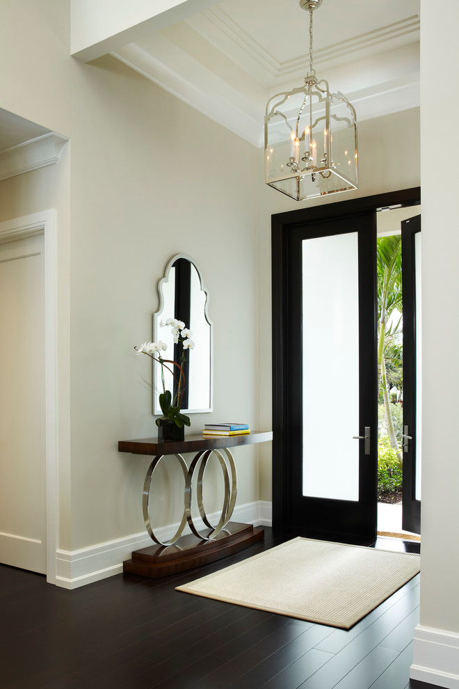This is an example of a transitional entryway in Miami with beige walls.