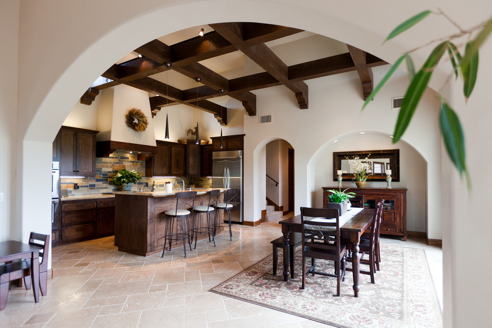 Design ideas for a mid-sized mediterranean single-wall eat-in kitchen in San Luis Obispo with shaker cabinets, medium wood cabinets, limestone benchtops, multi-coloured splashback, slate splashback, stainless steel appliances, travertine floors, with island and beige floor.