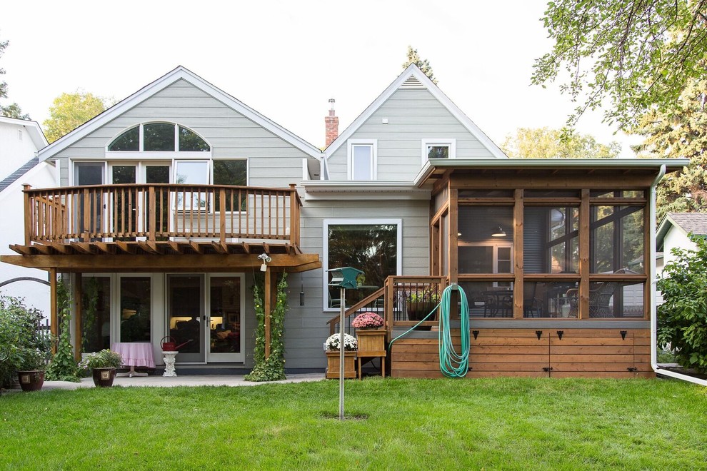 Inspiration for a mid-sized transitional backyard deck remodel with a roof extension