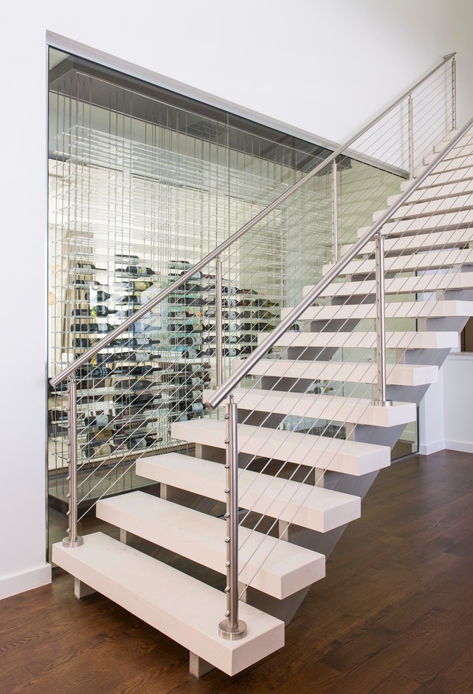 Design ideas for a contemporary floating staircase in Dallas with open risers and cable railing.