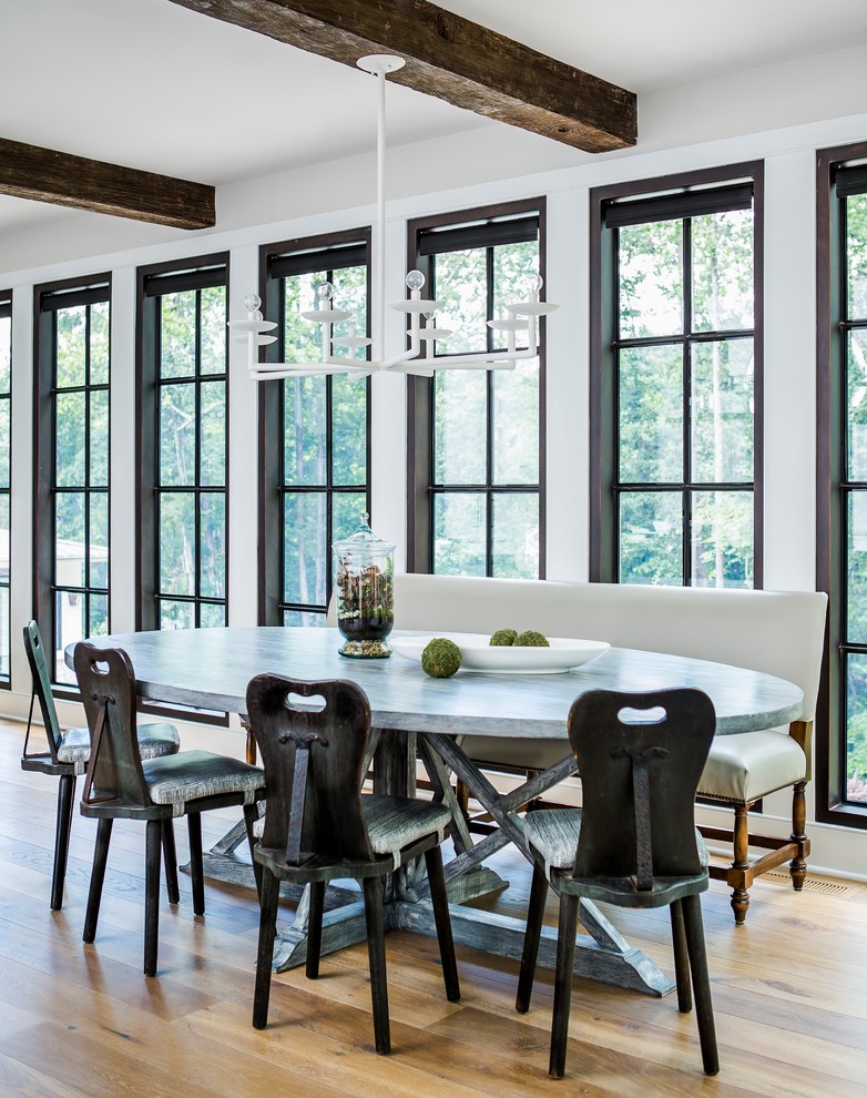 Inspiration for a beach style dining room in Atlanta with white walls and light hardwood floors.