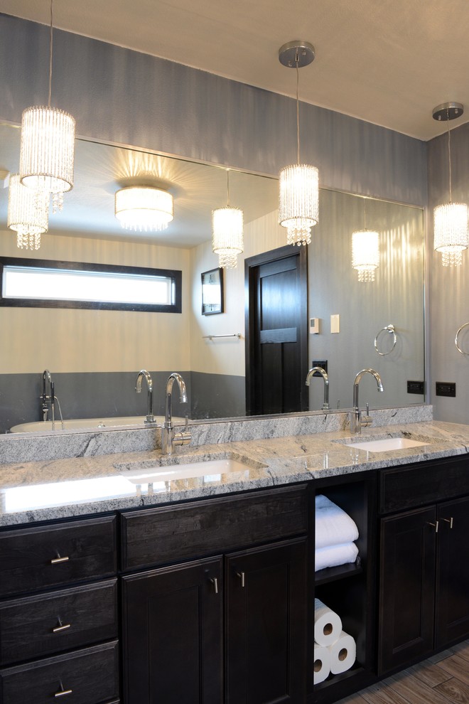 Freestanding bathtub - transitional master brown tile and ceramic tile porcelain tile freestanding bathtub idea with an undermount sink, shaker cabinets, dark wood cabinets, quartz countertops, a two-piece toilet and gray walls