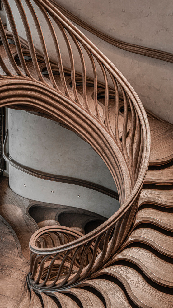 Inspiration for a large eclectic wood spiral staircase in London with wood railing.