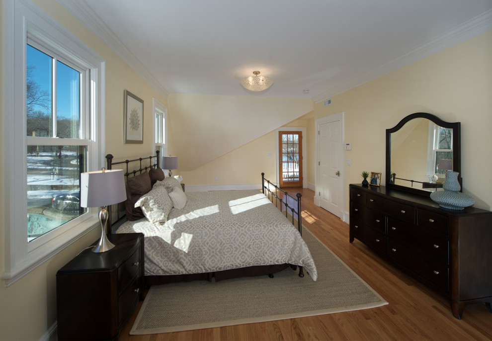 Design ideas for a mid-sized traditional master bedroom in Boston with yellow walls, medium hardwood floors, no fireplace and beige floor.