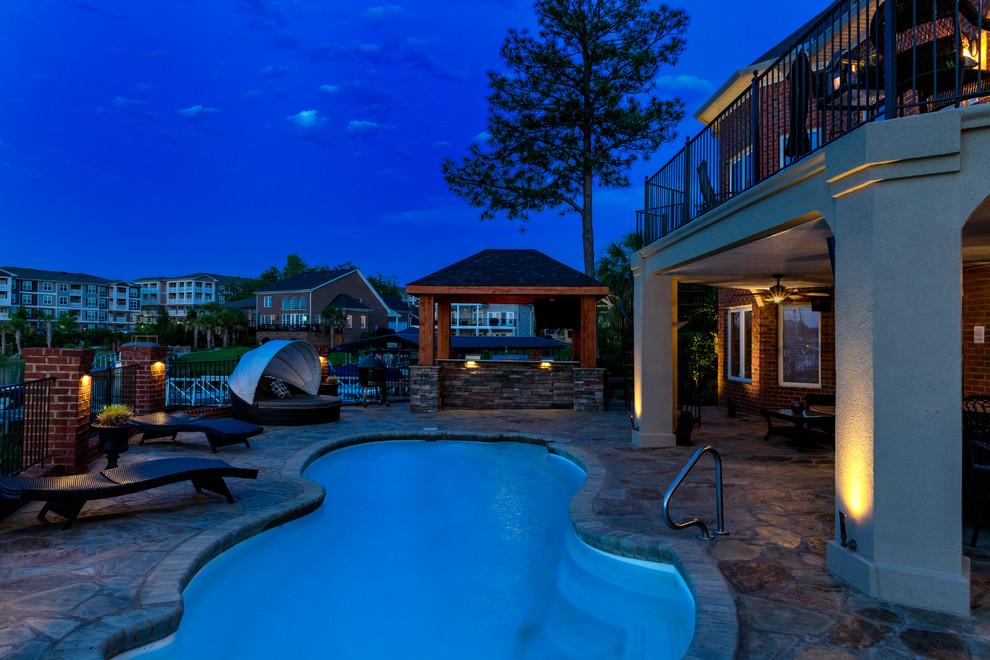Mid-sized arts and crafts backyard kidney-shaped pool in Richmond with natural stone pavers.