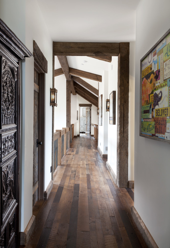 Hallway - huge cottage dark wood floor hallway idea in Denver with white walls