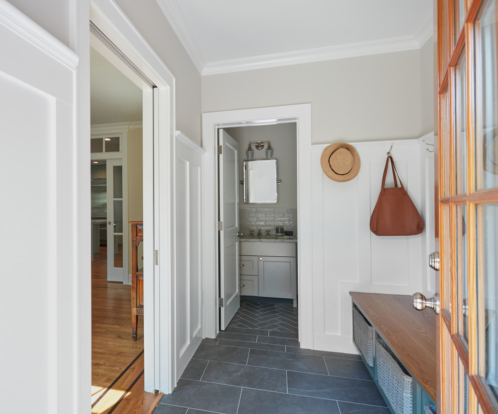 Design ideas for a small transitional mudroom in New York with grey walls, porcelain floors, a single front door, a white front door, grey floor and decorative wall panelling.