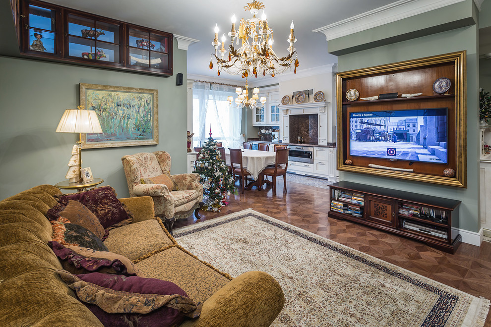 This is an example of a mid-sized traditional formal open concept living room in Moscow with green walls, no fireplace, a wall-mounted tv, dark hardwood floors and brown floor.