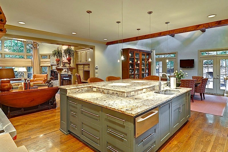 This is an example of a large traditional l-shaped open plan kitchen in Nashville with an undermount sink, recessed-panel cabinets, grey cabinets, granite benchtops, grey splashback, subway tile splashback, stainless steel appliances, medium hardwood floors, with island and brown floor.