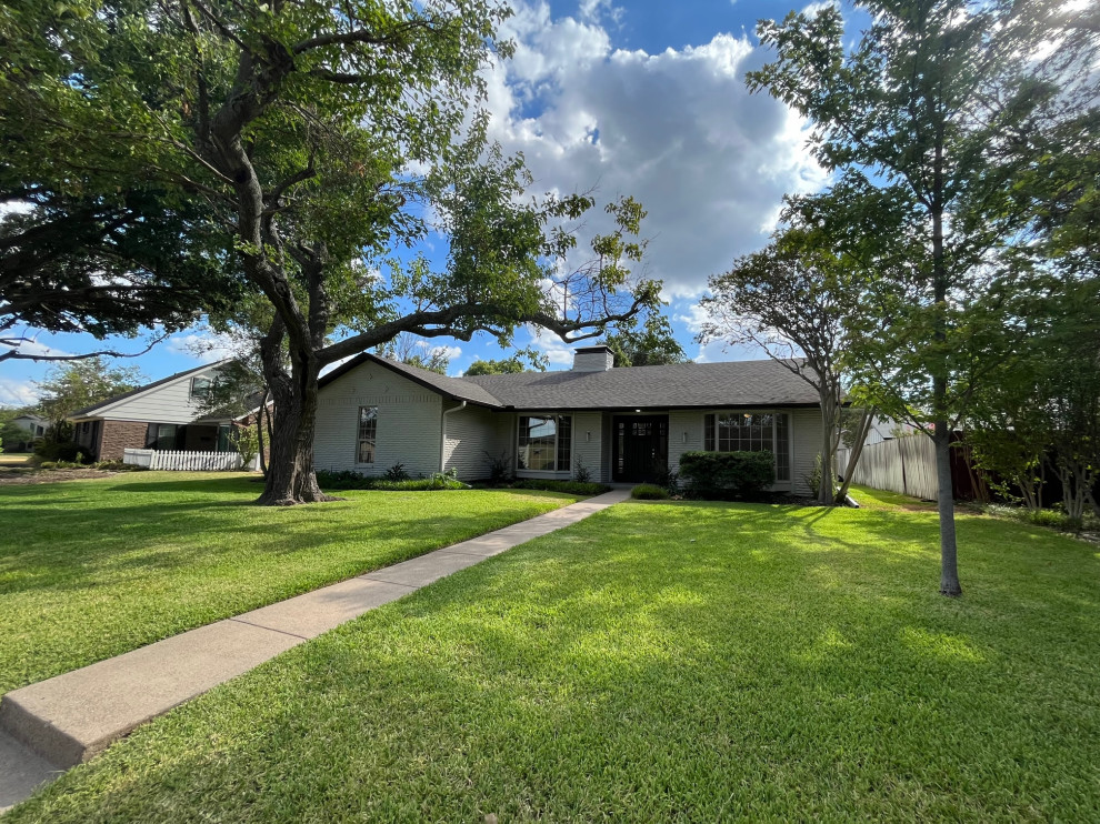 Mid-sized transitional beige one-story brick and board and batten gable roof photo in Dallas with a shingle roof and a brown roof