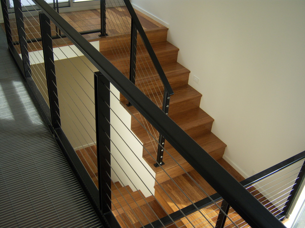 This is an example of a modern wood u-shaped staircase in Seattle with wood risers.