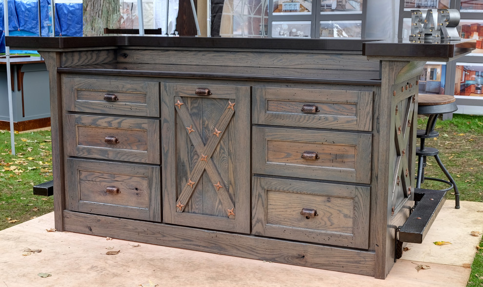 Small mountain style single-wall seated home bar photo with recessed-panel cabinets, distressed cabinets and quartz countertops