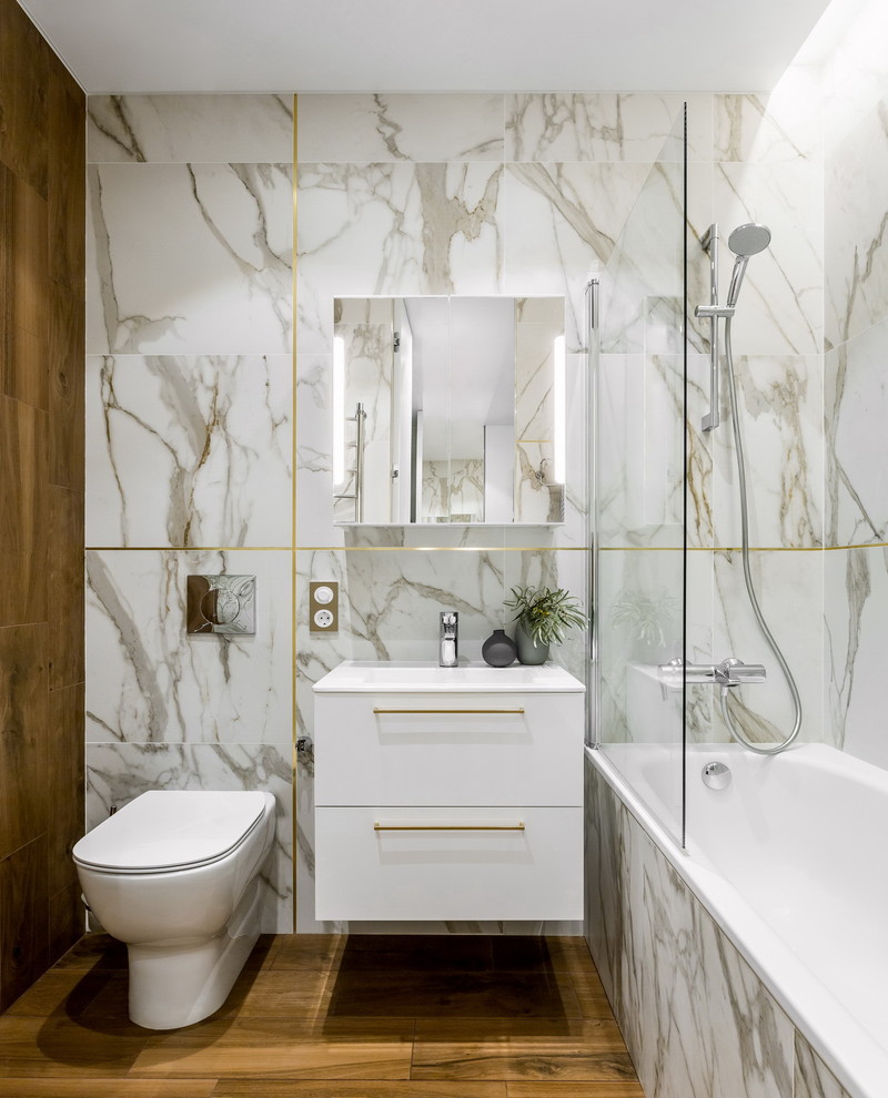 Photo of a small contemporary master bathroom in Moscow with flat-panel cabinets, white cabinets, porcelain floors, brown floor, an alcove tub, a shower/bathtub combo, a two-piece toilet, white tile, an integrated sink and an open shower.