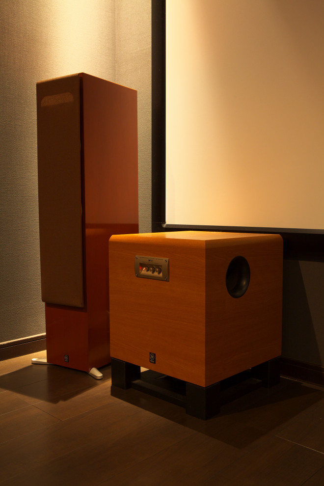 This is an example of a modern home theatre in Other with grey walls, painted wood floors, a projector screen and brown floor.