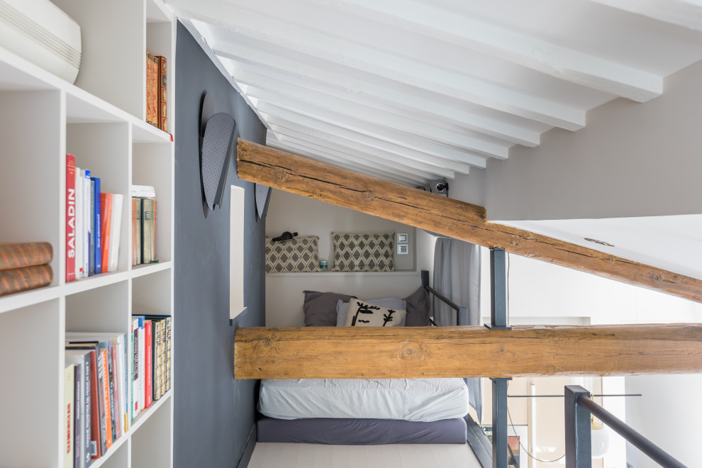 Small eclectic guest bedroom in Paris with black walls, painted wood floors, white floor and exposed beam.