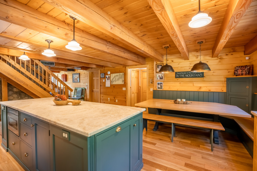 Photo of a rustic l-shaped kitchen/diner in Portland Maine with an island, light hardwood flooring, beige floors, white worktops, exposed beams and quartz worktops.
