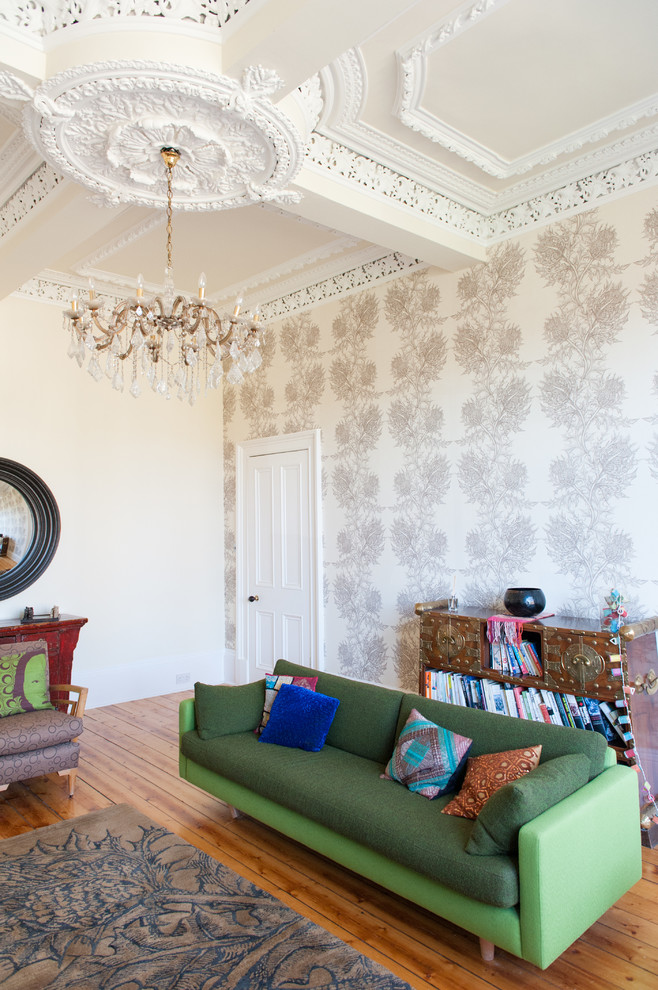 Eclectic living room in Glasgow with multi-coloured walls and medium hardwood floors.