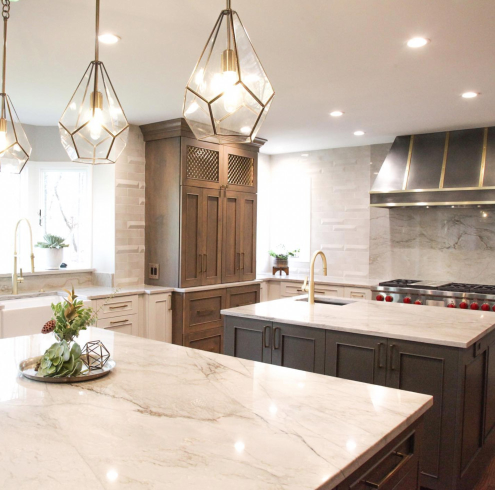 Example of a large transitional l-shaped open concept kitchen design with beaded inset cabinets, light wood cabinets, white backsplash, marble backsplash, stainless steel appliances and two islands