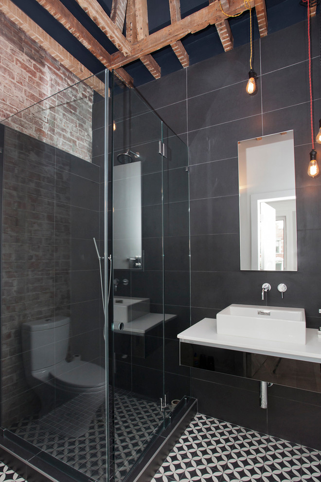 This is an example of a mid-sized contemporary 3/4 bathroom in New York with a vessel sink, a corner shower, gray tile and grey walls.