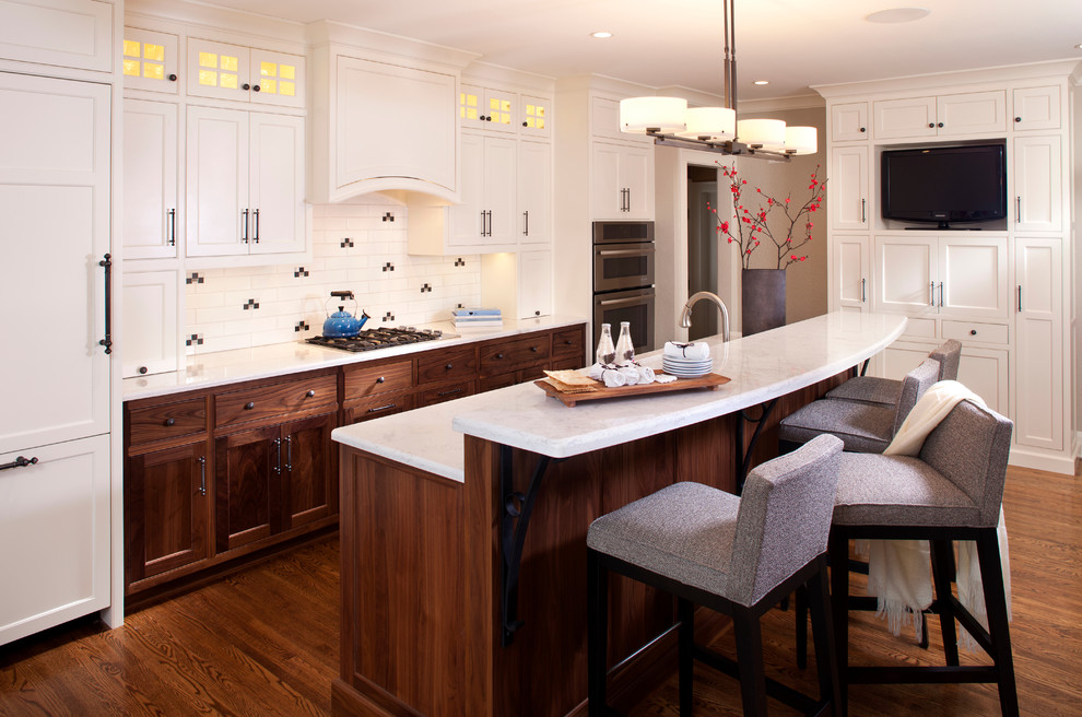 Design ideas for a mid-sized transitional galley open plan kitchen in Minneapolis with white cabinets, quartz benchtops, panelled appliances, ceramic splashback, dark hardwood floors, with island, an undermount sink, shaker cabinets and multi-coloured splashback.