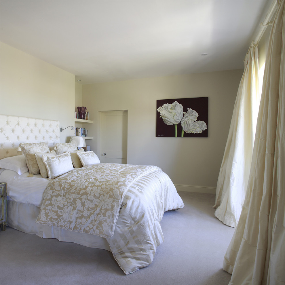Photo of a traditional master bedroom in Dublin with beige walls and carpet.