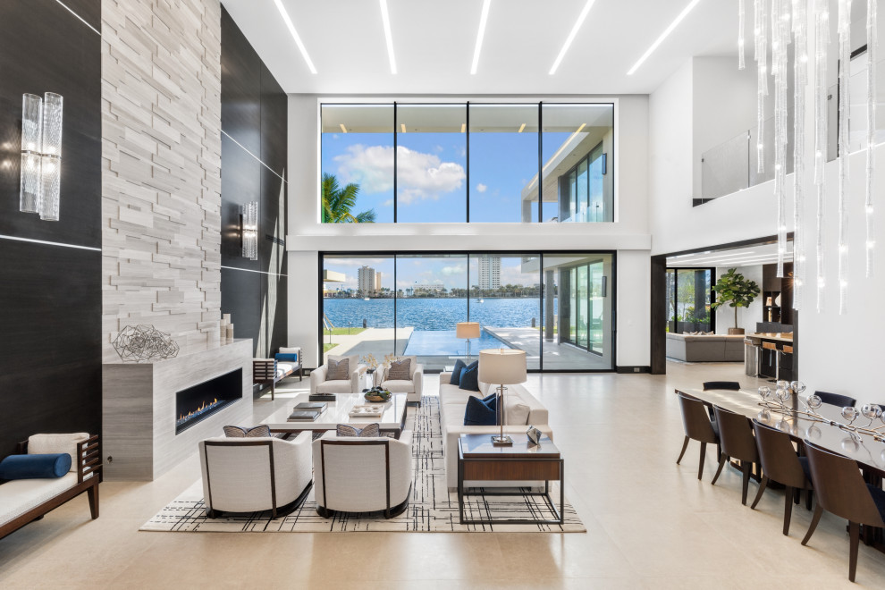 Inspiration for a large contemporary open concept living room in Miami with white walls, a ribbon fireplace and beige floor.
