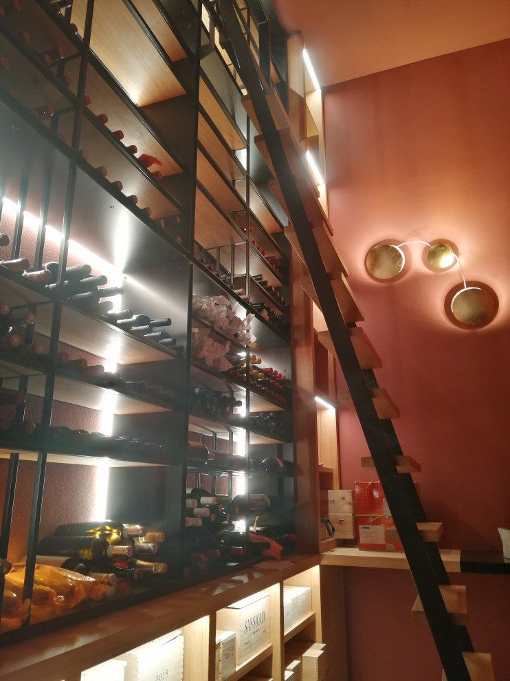 Photo of a mid-sized arts and crafts wine cellar in Milan with marble floors, display racks and grey floor.