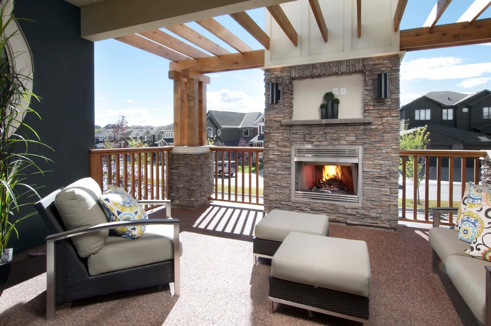 Photo of a mid-sized traditional patio in Calgary with a fire feature and a pergola.