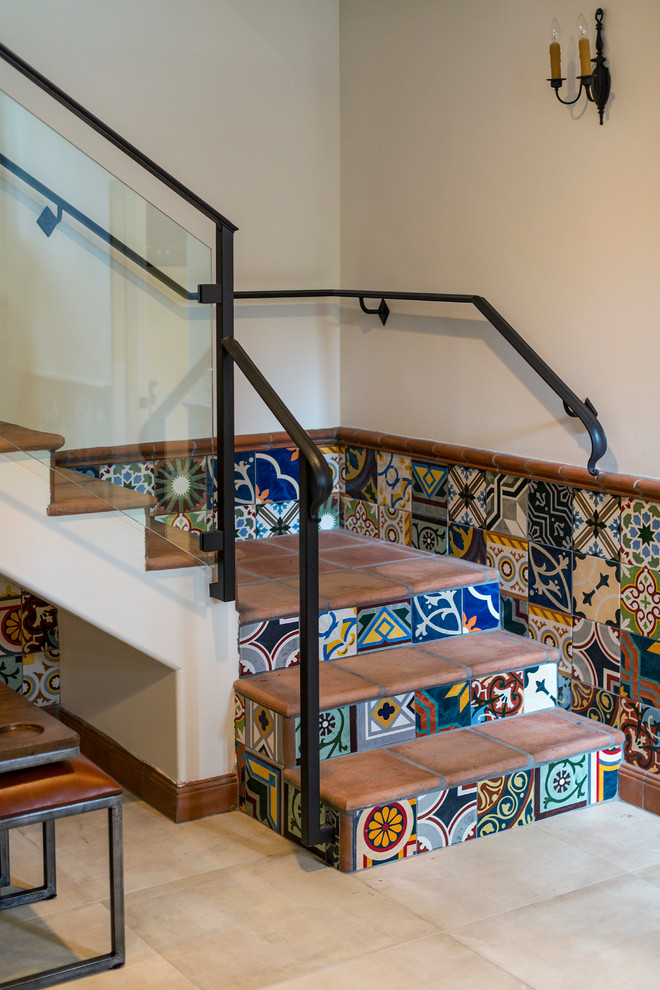 Design ideas for a mid-sized mediterranean tile curved staircase in Los Angeles with tile risers.