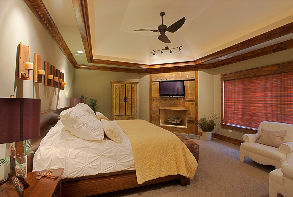 This is an example of a mid-sized arts and crafts master bedroom in Chicago with green walls, carpet, a standard fireplace and a wood fireplace surround.