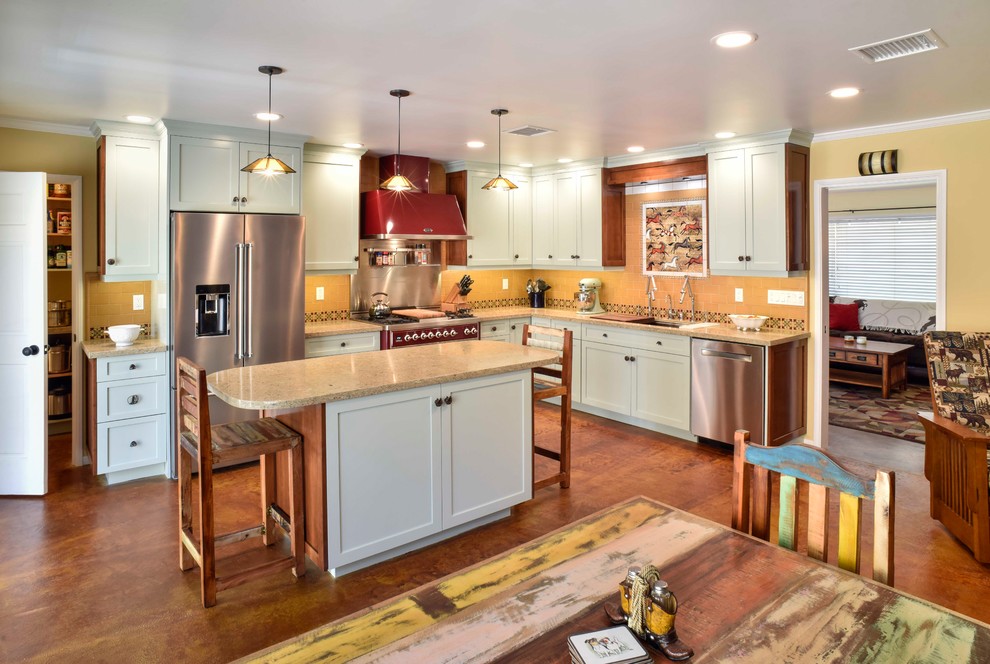 Mid-sized transitional l-shaped eat-in kitchen in Los Angeles with an undermount sink, shaker cabinets, green cabinets, stainless steel appliances, concrete floors, with island, brown floor, beige benchtop, quartz benchtops and brown splashback.