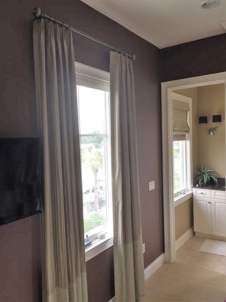 Inspiration for a mid-sized transitional guest dark wood floor and brown floor bedroom remodel in Tampa with beige walls and no fireplace