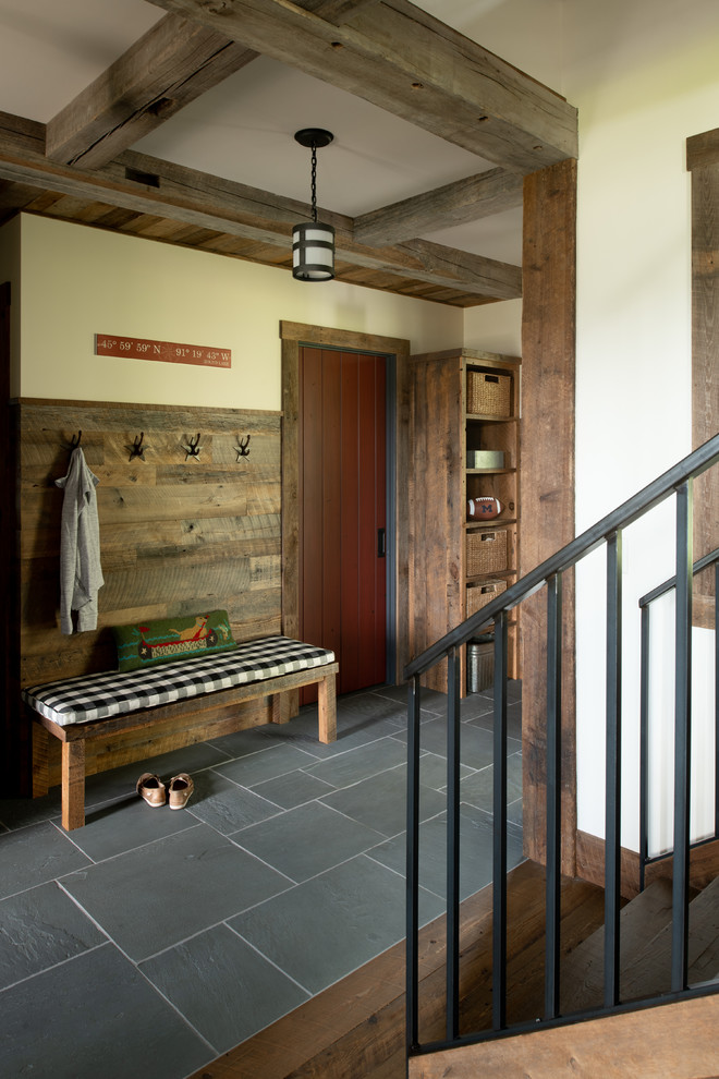 Design ideas for a country entryway in Minneapolis with beige walls and grey floor.