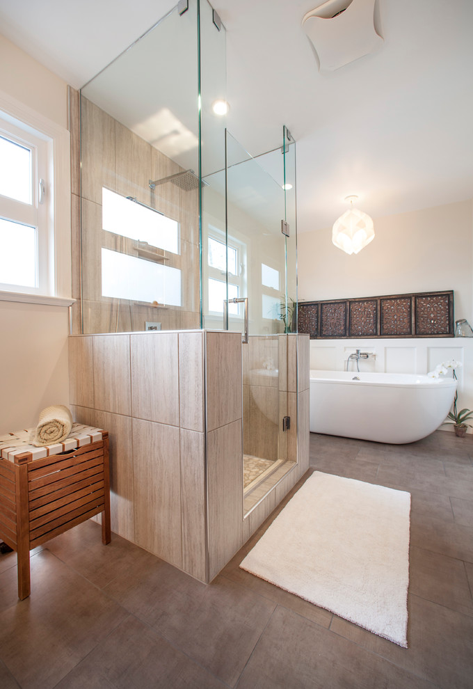 Large transitional master bathroom in Other with a freestanding tub, an alcove shower, beige tile, porcelain tile, beige walls, porcelain floors, brown floor and a hinged shower door.