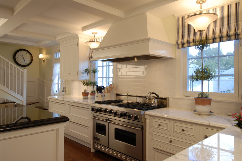 This is an example of a traditional kitchen in San Diego with beaded inset cabinets, white cabinets, marble benchtops, white splashback, subway tile splashback and stainless steel appliances.