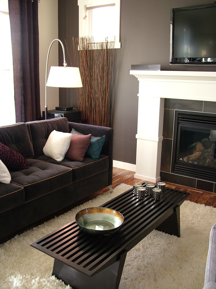 Photo of a contemporary living room in Calgary with a tile fireplace surround.