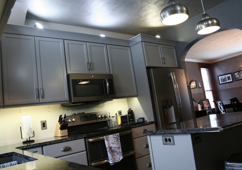 Enclosed kitchen - small transitional l-shaped vinyl floor enclosed kitchen idea with a double-bowl sink, flat-panel cabinets, gray cabinets, quartz countertops, stainless steel appliances and an island