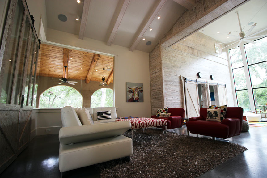 Large contemporary enclosed family room in Denver with white walls, concrete floors and no fireplace.