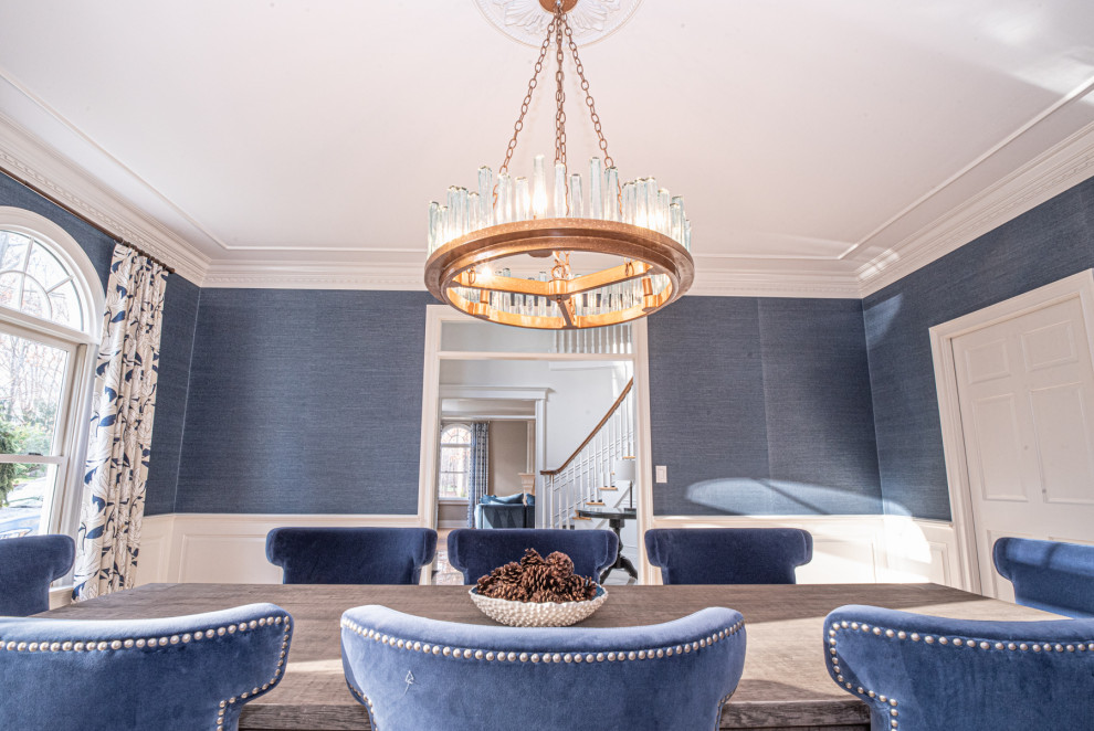 Mid-sized transitional medium tone wood floor and wallpaper enclosed dining room photo in New York with blue walls