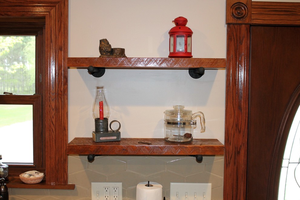 Eat-in kitchen - mid-sized rustic l-shaped vinyl floor and beige floor eat-in kitchen idea with a farmhouse sink, raised-panel cabinets, medium tone wood cabinets, laminate countertops, beige backsplash, cement tile backsplash, stainless steel appliances, a peninsula and beige countertops