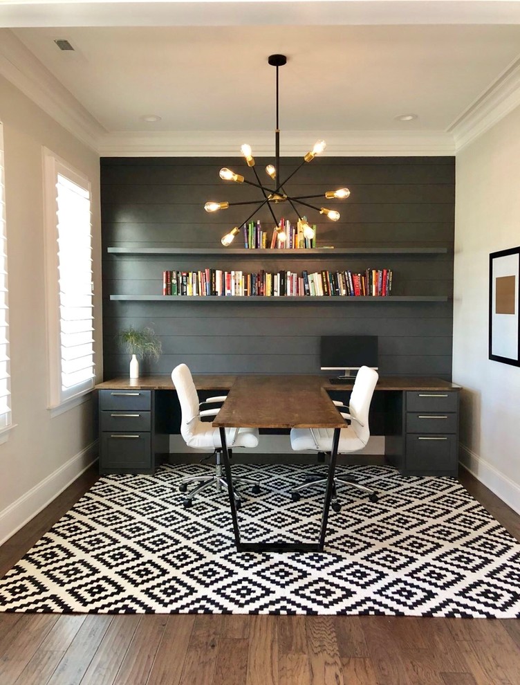 Inspiration for a contemporary study room in Charlotte with grey walls, dark hardwood floors, a built-in desk and brown floor.