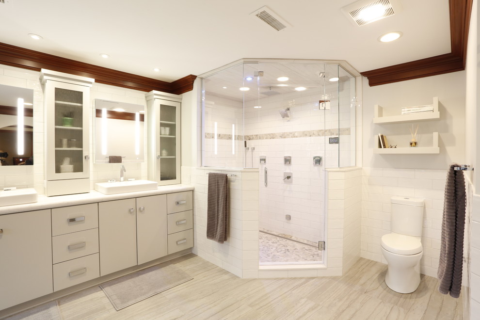 Design ideas for a large transitional master bathroom in Cleveland with flat-panel cabinets, white cabinets, a freestanding tub, a corner shower, white tile, white walls, a vessel sink, quartzite benchtops, grey floor, a hinged shower door and white benchtops.