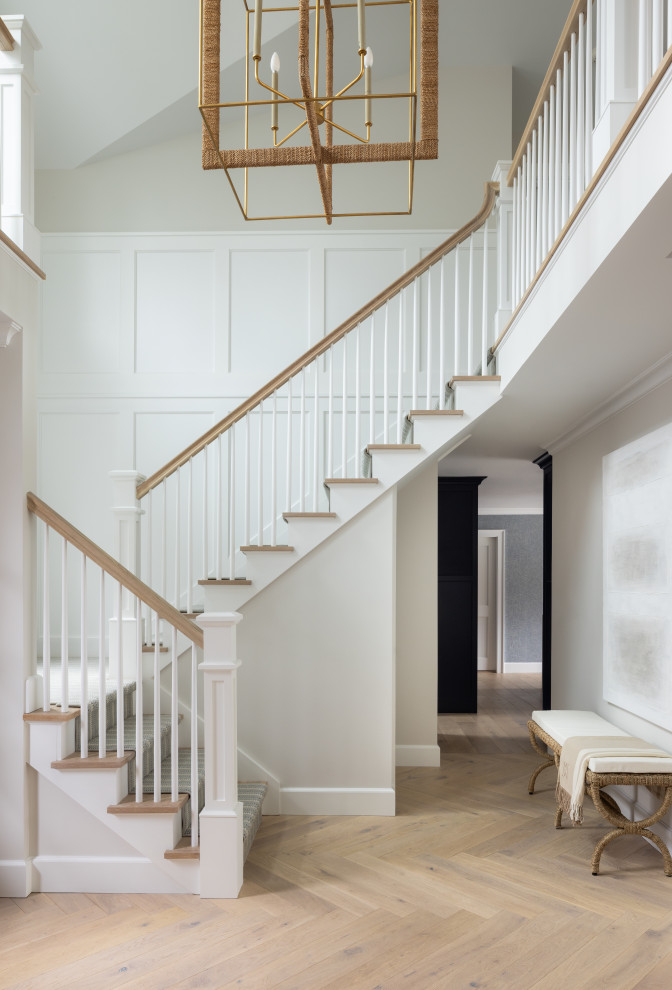 Mid-sized transitional carpeted u-shaped wood railing and wainscoting staircase photo in New York with wooden risers