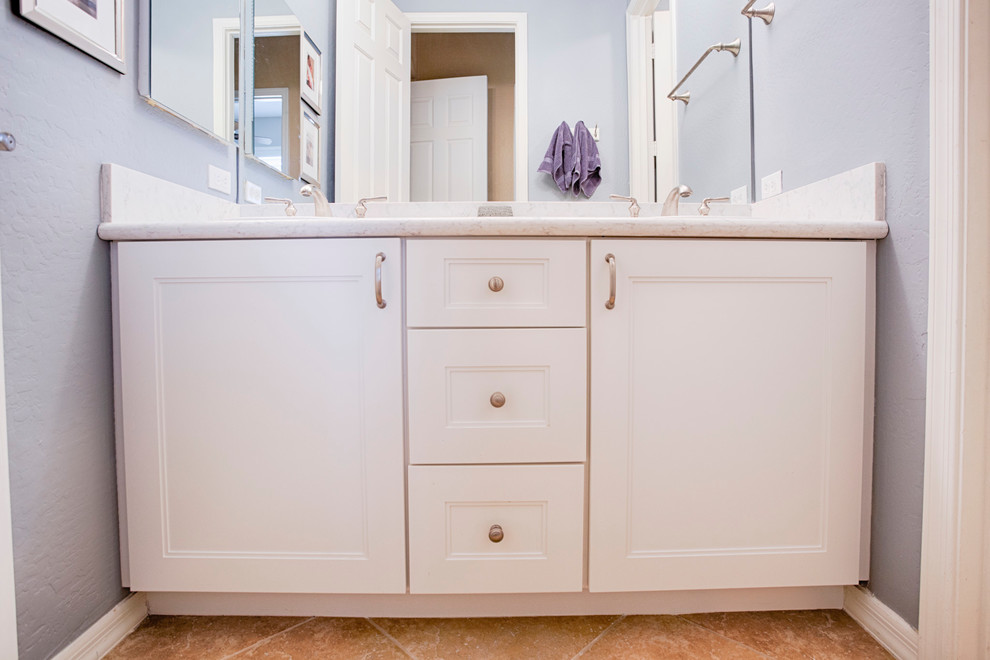 Large transitional master beige tile and travertine tile travertine floor corner shower photo in Phoenix with recessed-panel cabinets, white cabinets, green walls, an undermount sink and granite countertops