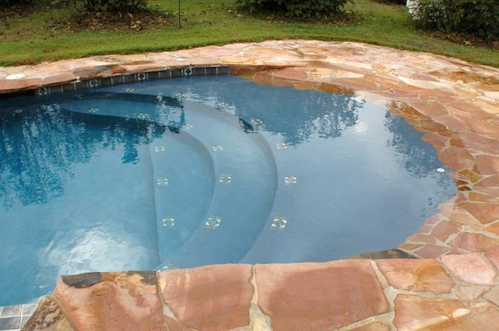 Pool fountain - mid-sized backyard stone and rectangular natural pool fountain idea