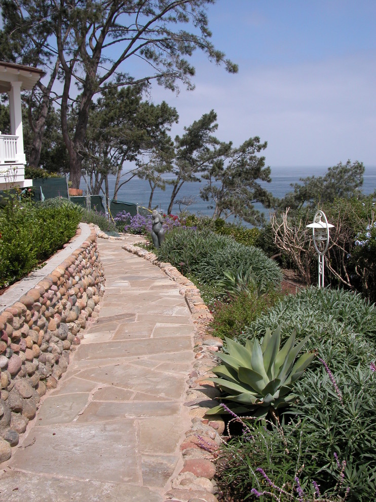 Design ideas for a beach style garden in San Diego with a retaining wall.