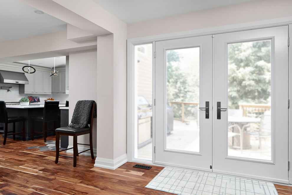 Home design - transitional medium tone wood floor and brown floor home design idea in Toronto with white walls